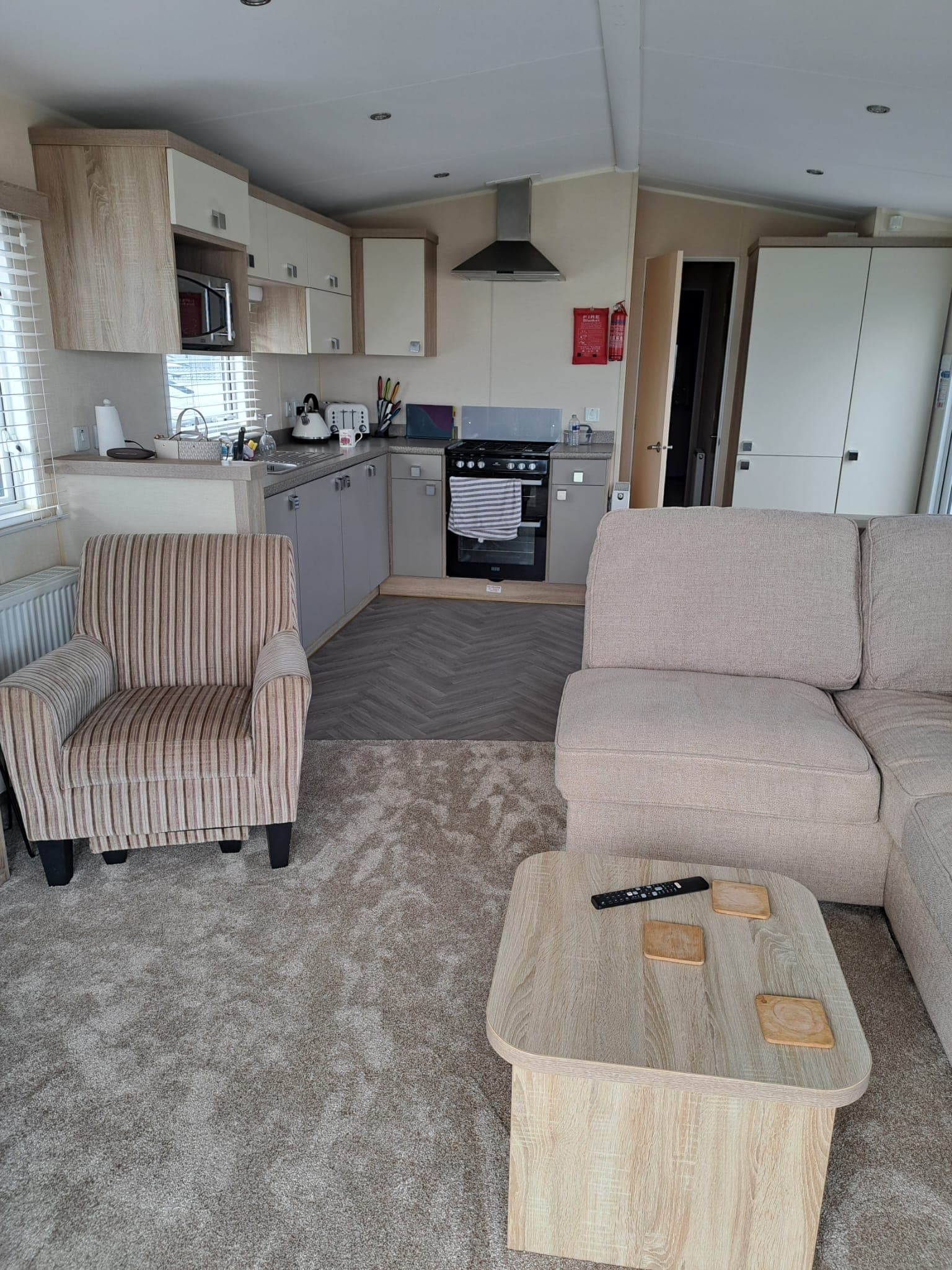 Kitchen with full-height fridge, gas hob and oven, and a dining nook